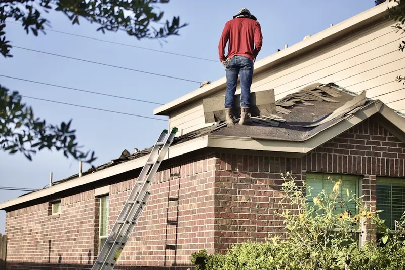 Professional roofer working on a residential roof in Henderson